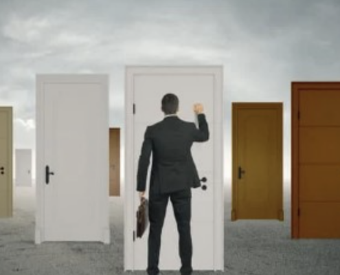 Businessman standing in front of multiple doors, symbolizing choices and opportunities, highlighting how Dallas IT Consulting helps businesses choose the right path for growth and success.